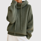 "Nora - Teplý pletený svetr s kapucí" could be rewritten as "Nora - Hřejivý pletený svetr s kapucí".