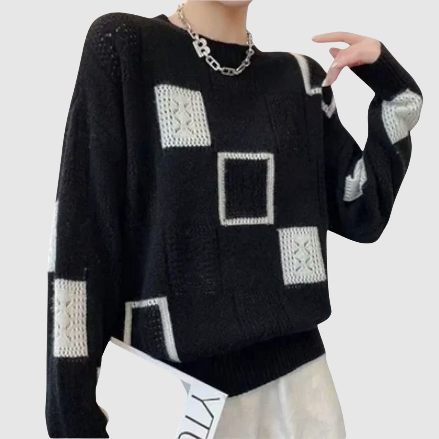 "Nora – Svetr s grafickými kontrasty" could be rewritten as "Nora – Svetr s výraznými grafickými prvky".