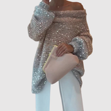 "Nora – Lesklý svetr s odhaleným ramenem" could be rewritten as "Nora – Lesklý svetr s jedním odhaleným ramenem".