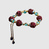 Liana – Umělecký náramek s červenými a modrými krystaly" can be rewritten as:

"Liana – Umělecký náramek s krystaly v červené a modré barvě